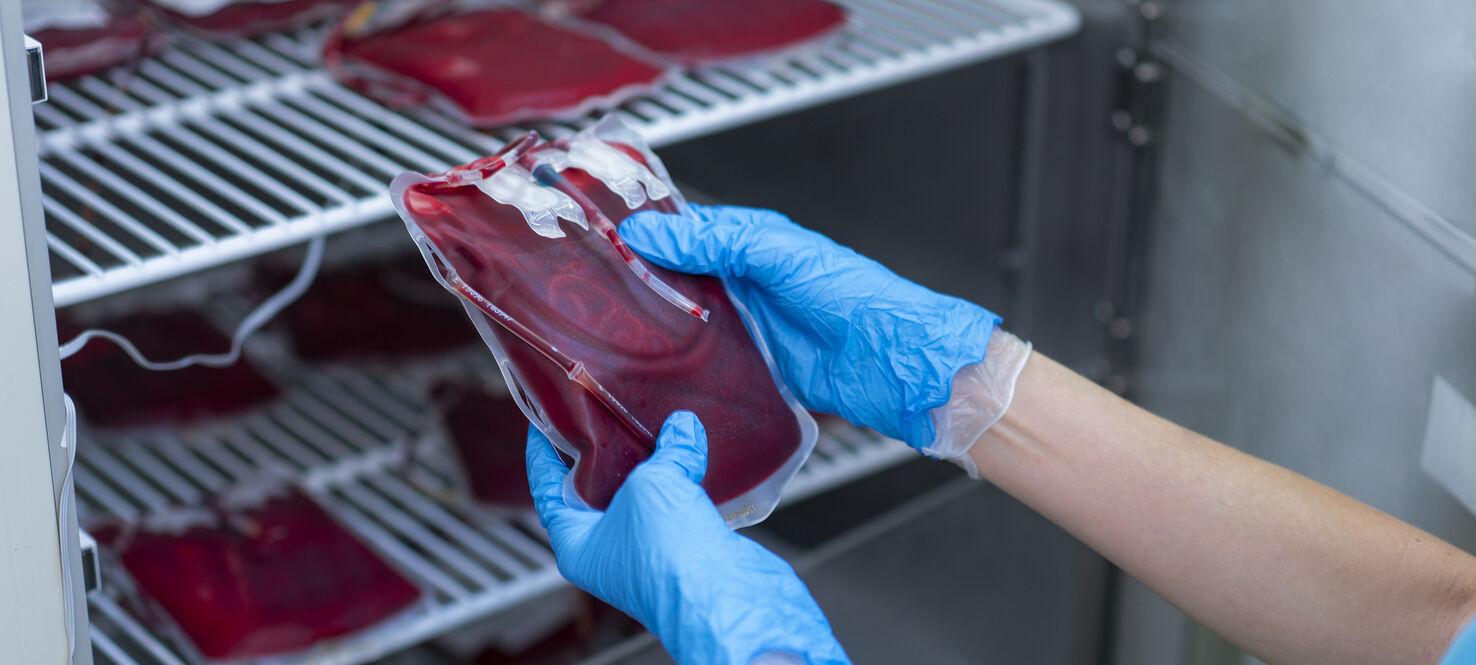 Bags of blood sitting on shelves 