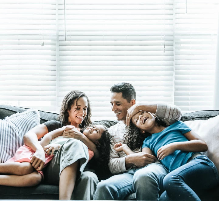 Portrait of young family of sofa at home 