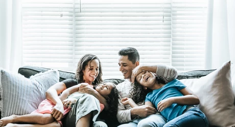 Portrait of young family of sofa at home 