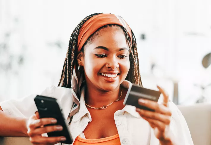 Smile, black woman and phone with credit card. 