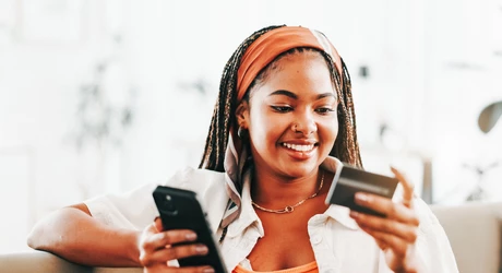 Smile, black woman and phone with credit card. 