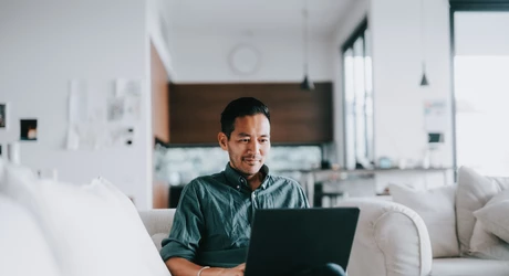 Man working with laptop at home 