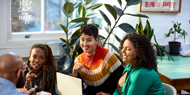 Business women talking to male colleague, informal meeting