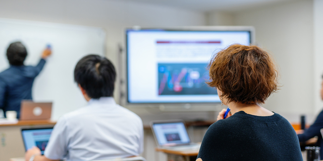 Mid adult woman in a continuing education class at a community college or university