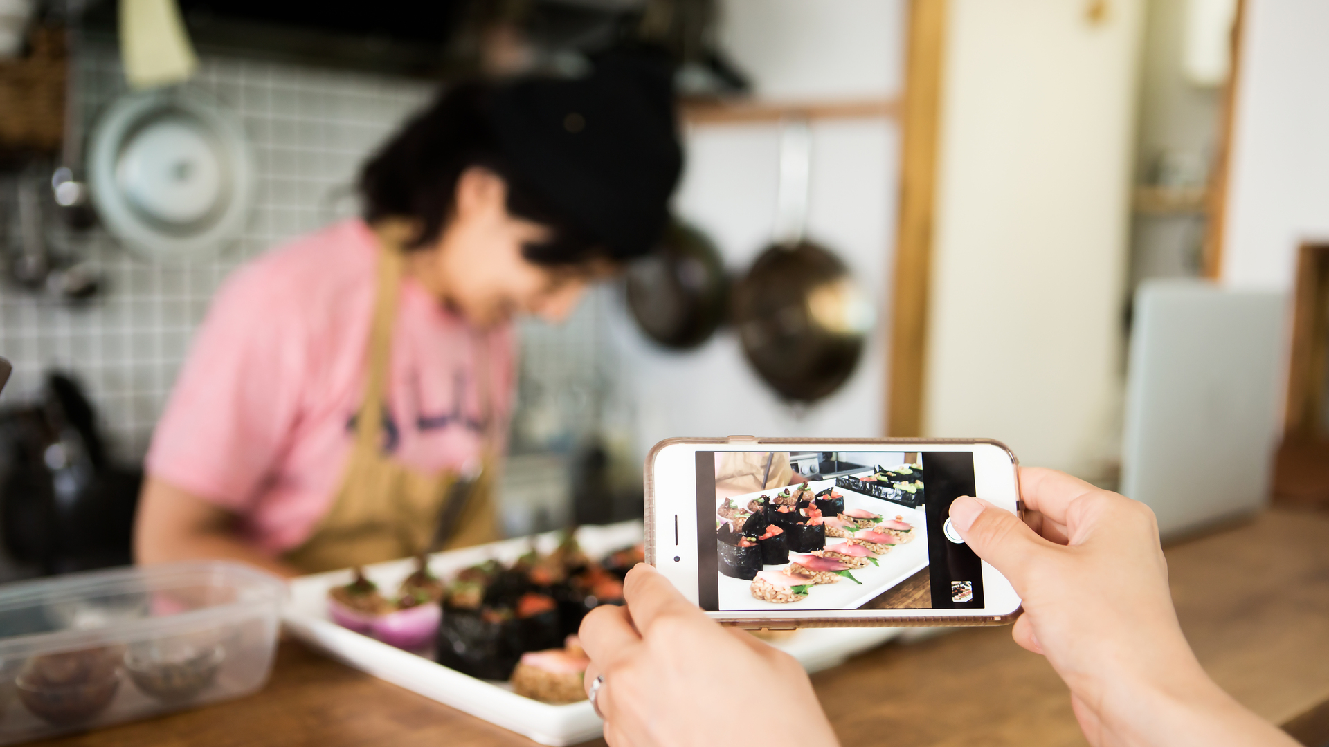 Customer shooting sushi made with vegan ingredients with smartphone