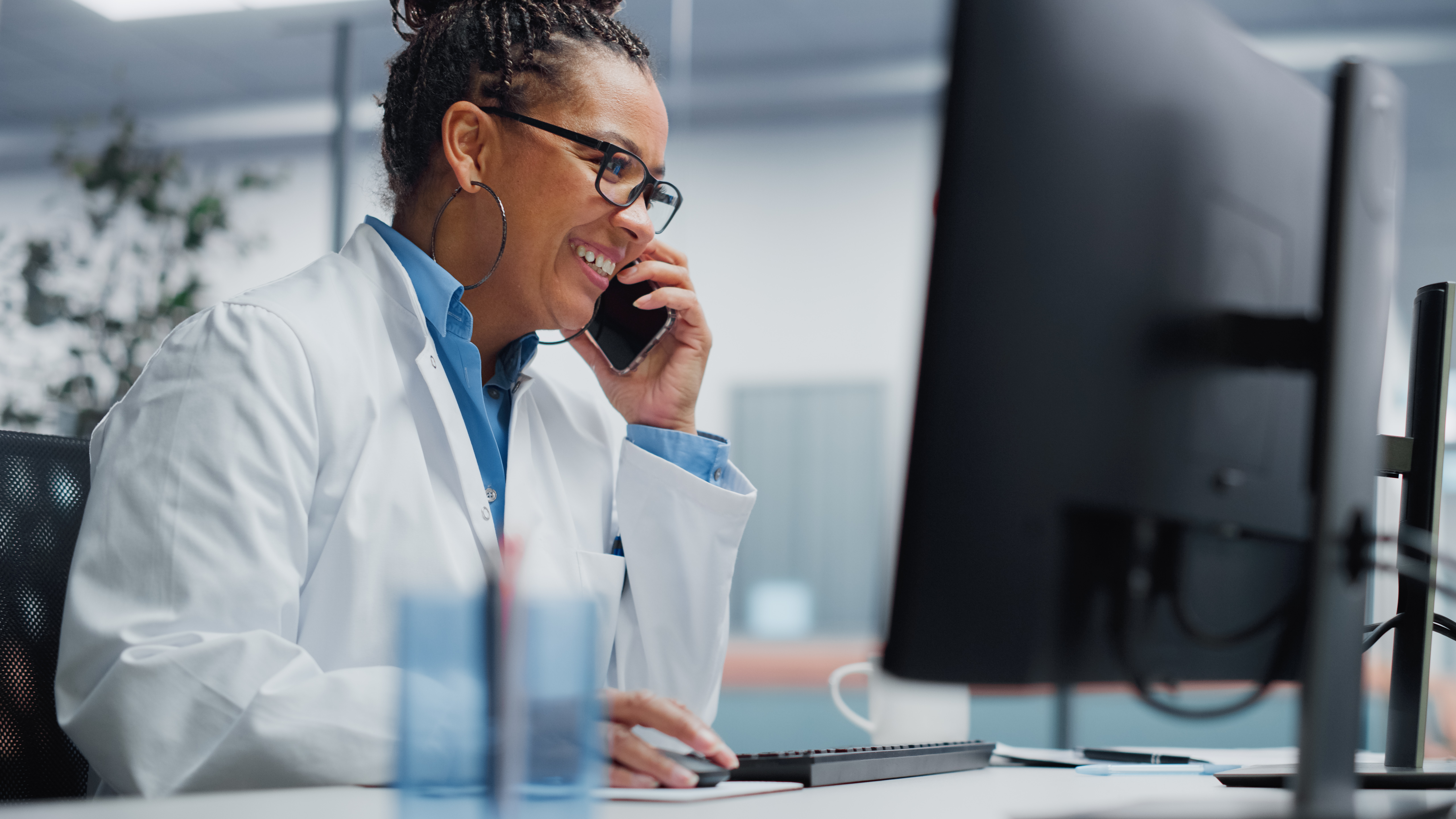 Medical Hospital Research Lab: Black Female Neurosurgeon Using Computer with Brain Scan MRI Images, Talking on the Phone with Sick Patient. Health Care Neurologist Finding Treatment. Energetic Arc