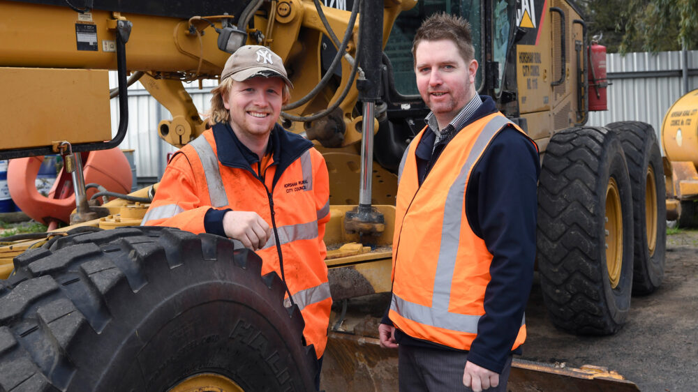 Photo of Skill Invest students in high vis standing by a truck