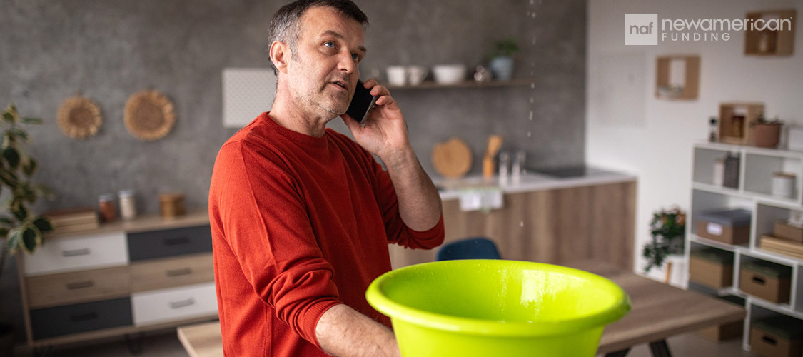 hand on the phone about leaking roof