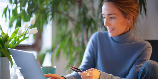 Woman using credit card for online shopping