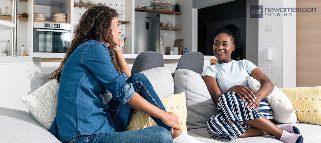 roommates having a discussion on the living room sofa