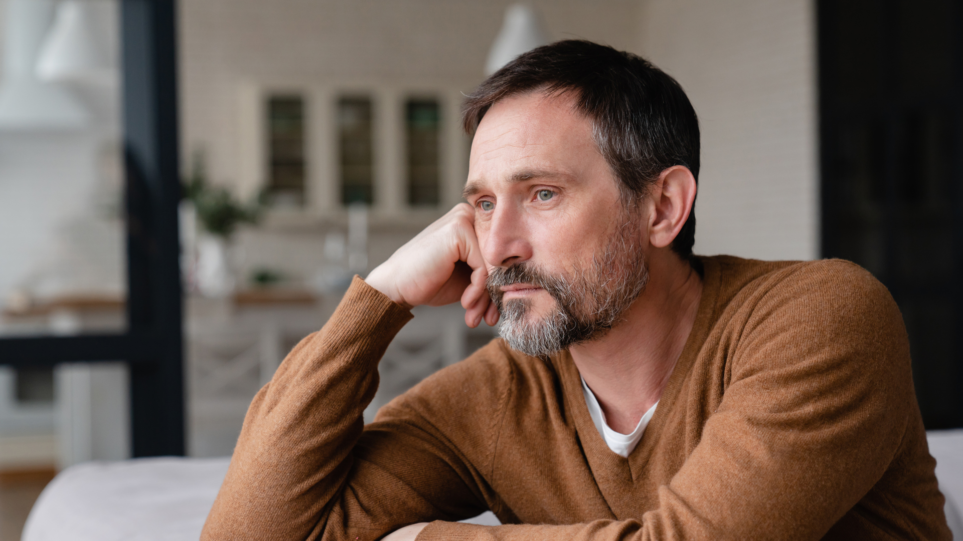 Bored tired sad mature middle-aged man depressed lonely having no visitors of his children. Divorce , bachelor , health problems concept. Lockdown, unemployment, needless man on social distance