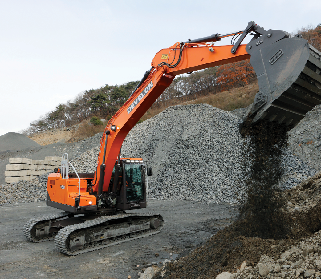 The new DEVELON -9 Series crawler excavator digging dirt on a job site.
