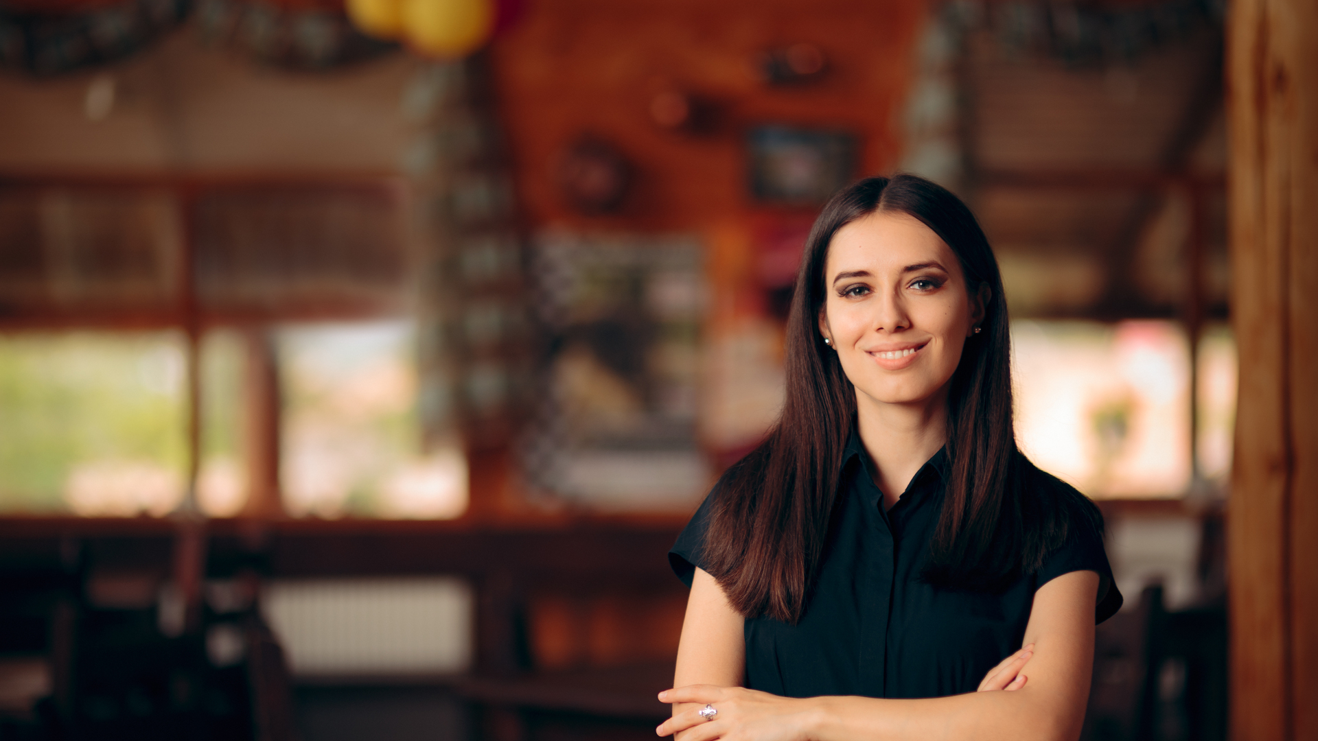 Manager Standing in a Restaurant Welcoming Customers