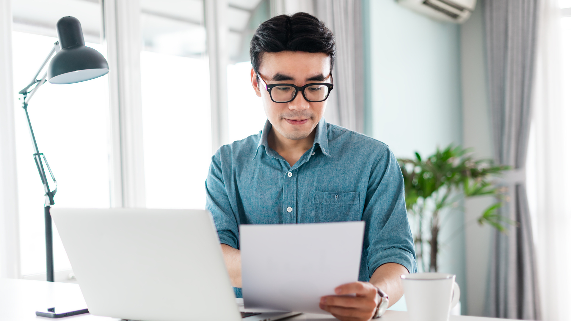 portrait of asian man sitting working from home