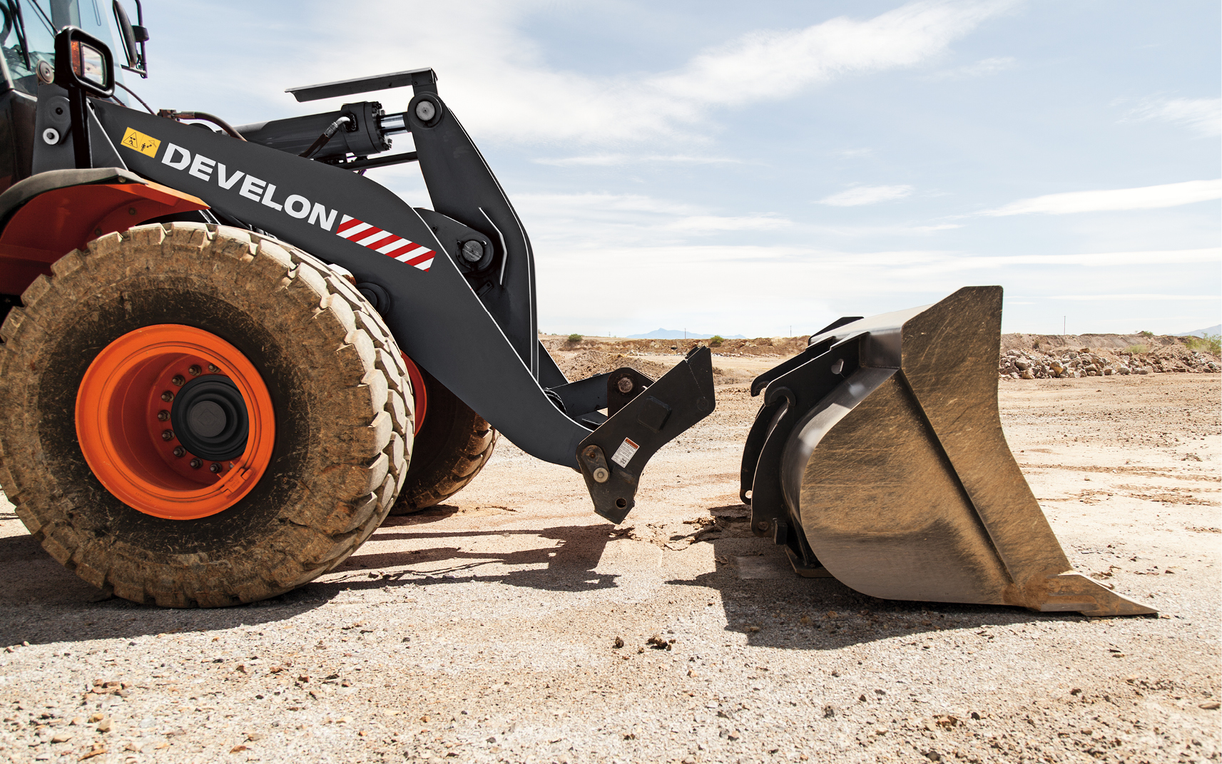 A DEVELON wheel loader quick coupler and bucket.