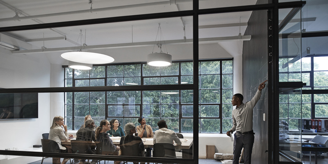 Businessman with coworkers in board room