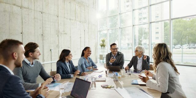 Team of executives talking in a meeting in the office.