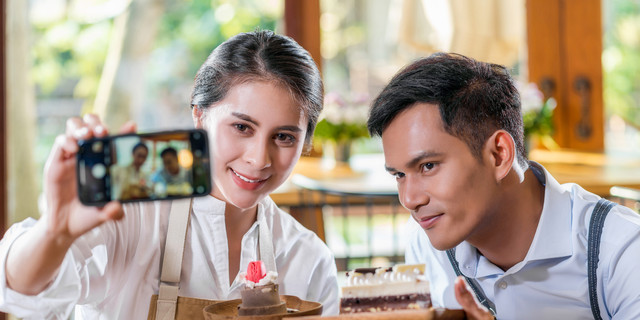 Couple Asian two partner of small business owner taking selfie and presenting the bakery in coffee shop when reccord vlog, Cake and dessert, entrepreneur blogger and startup business concept