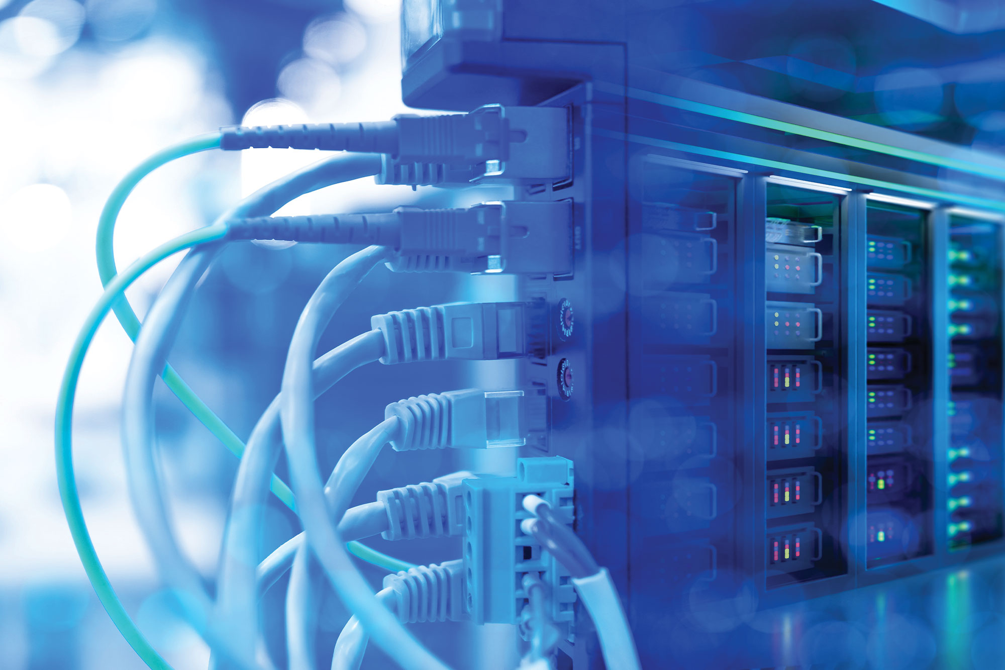 Fiber optic and Ethernet cables connected to a server rack for structured cabling installation