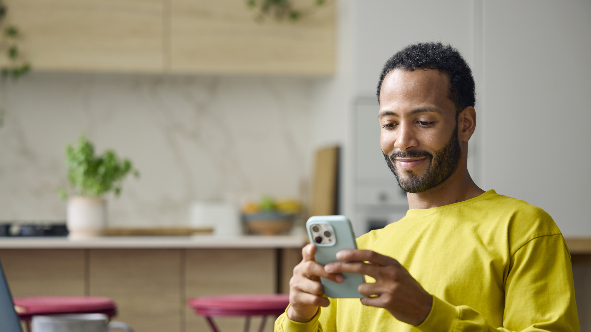 Freelancer using smart phone while working from home