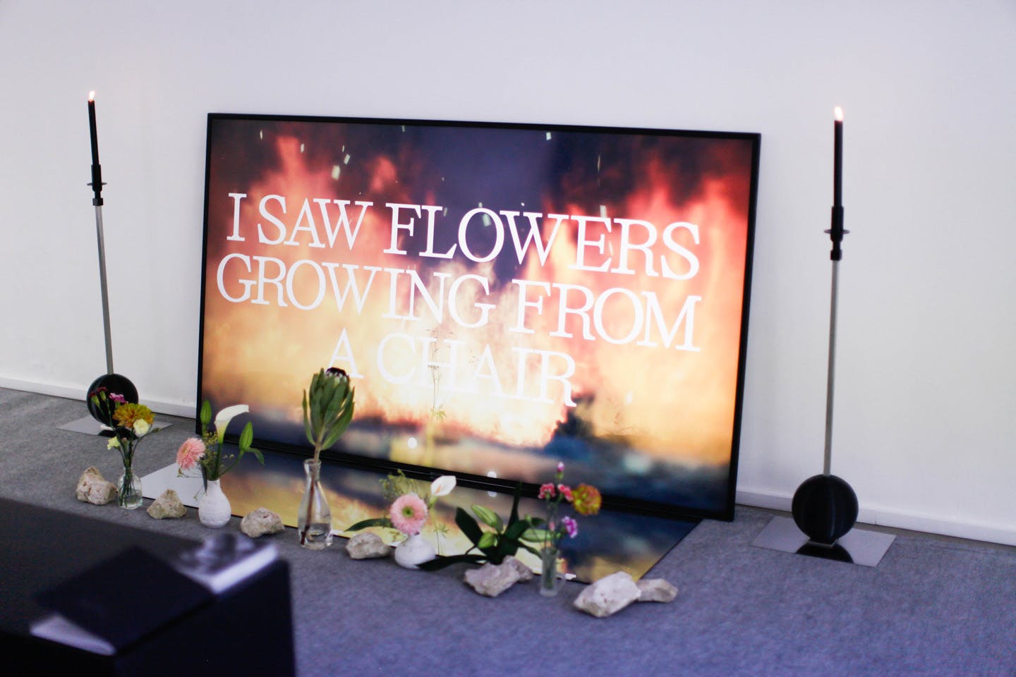 Digital artwork with flowers and text reading I saw flowers growing from a chair