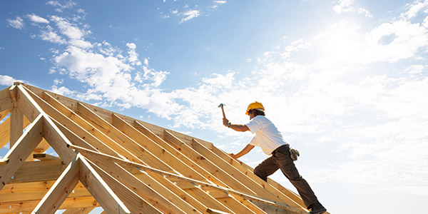 construction working building a roof for a new construction house