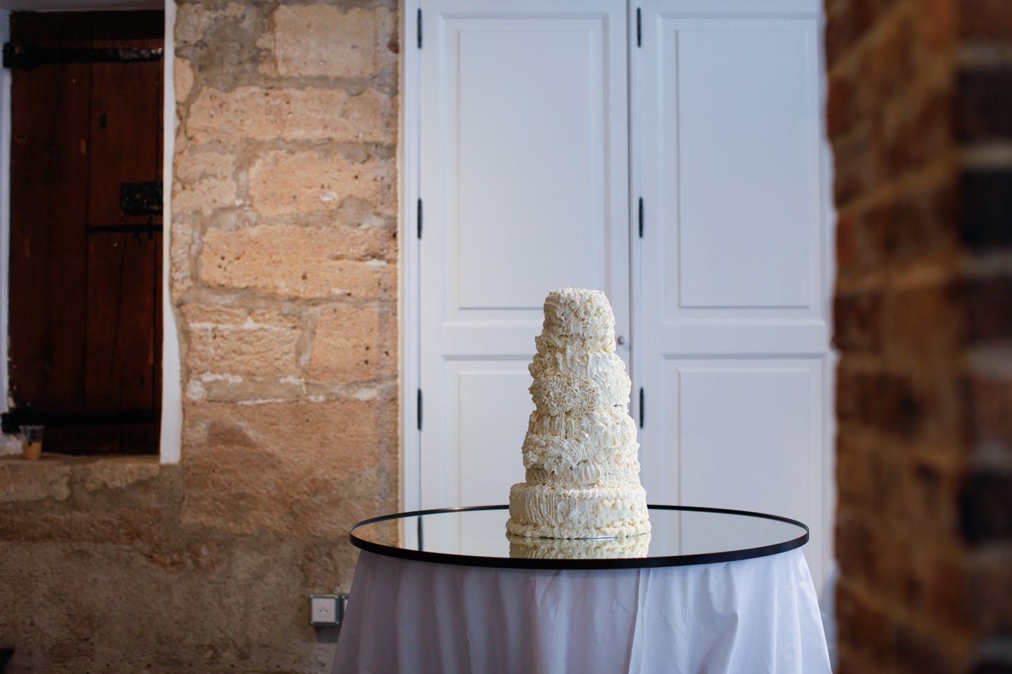 Textured white tiered sculpture resembling a wedding cake