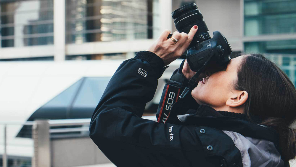 Picture of a photographer taking a picture above with a camera