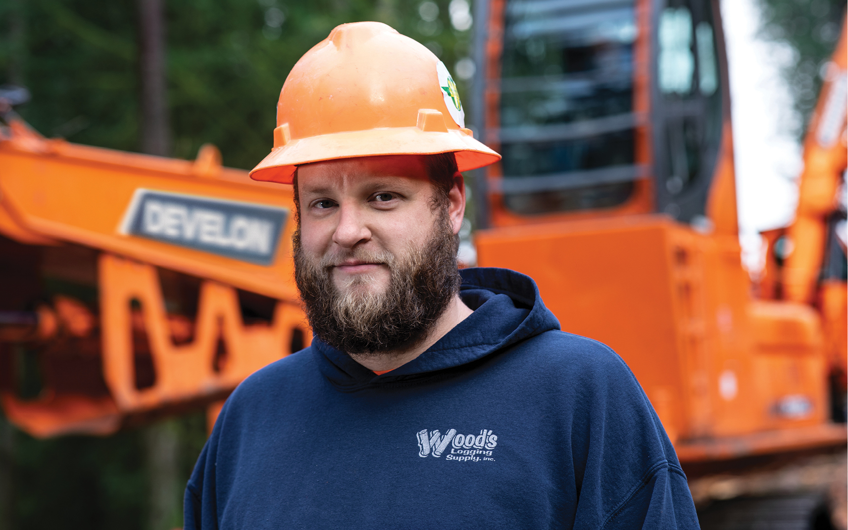 Shane Hiett standing in front of his DEVELON log loader.