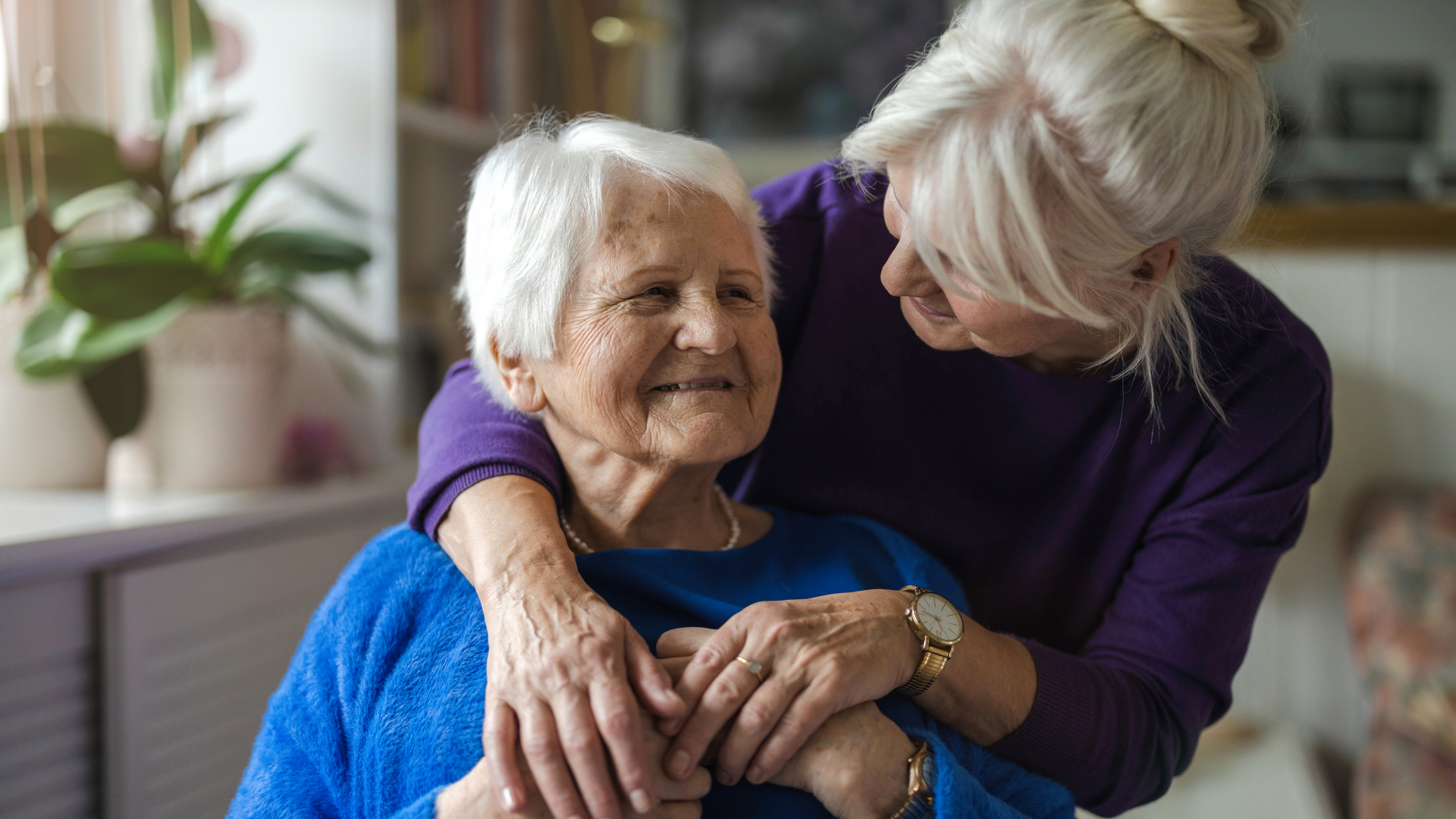 Woman hugging her elderly mother