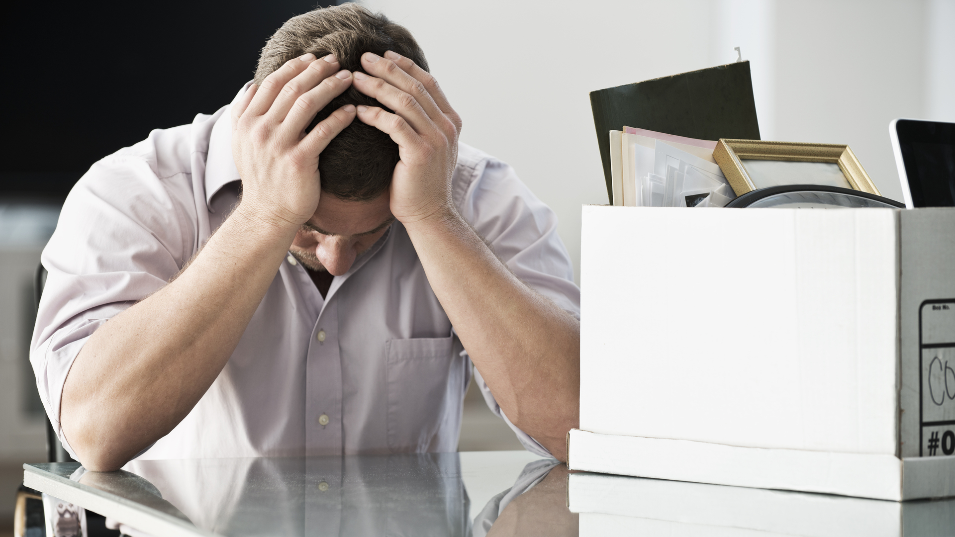 Businessman packing up box in office