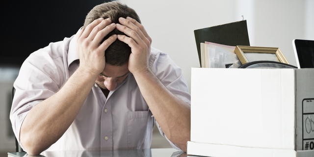 Businessman packing up box in office