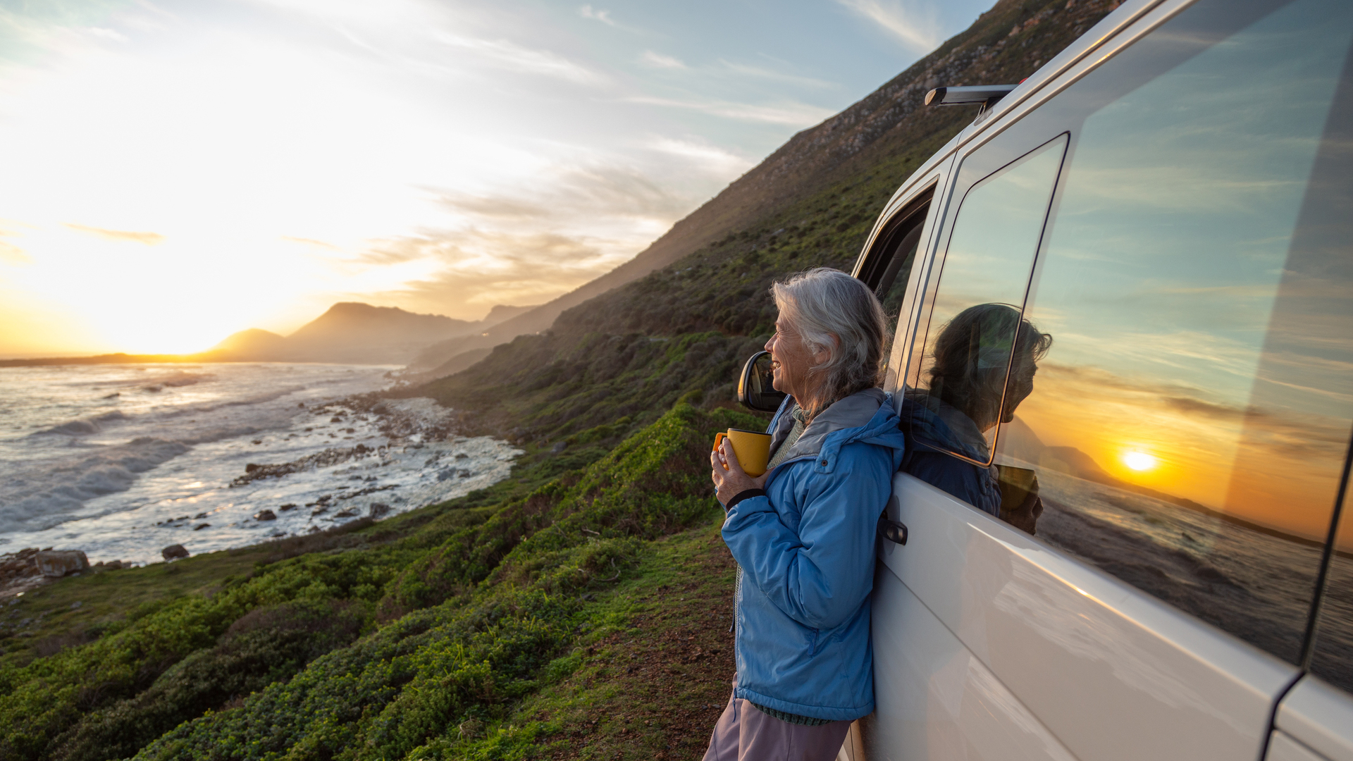 Senior woman enjoying sunset by the sea