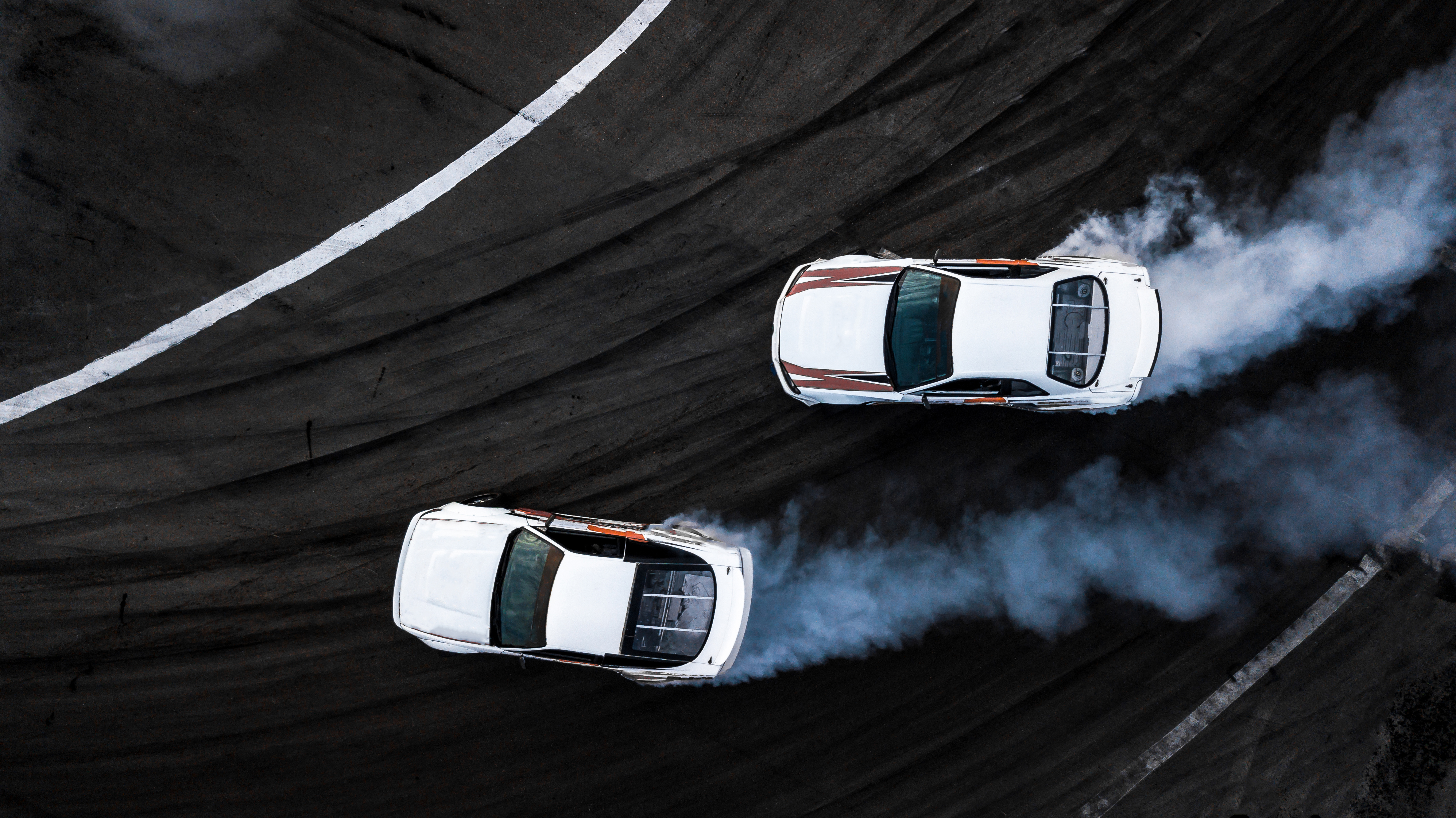 Two white race cars on the track