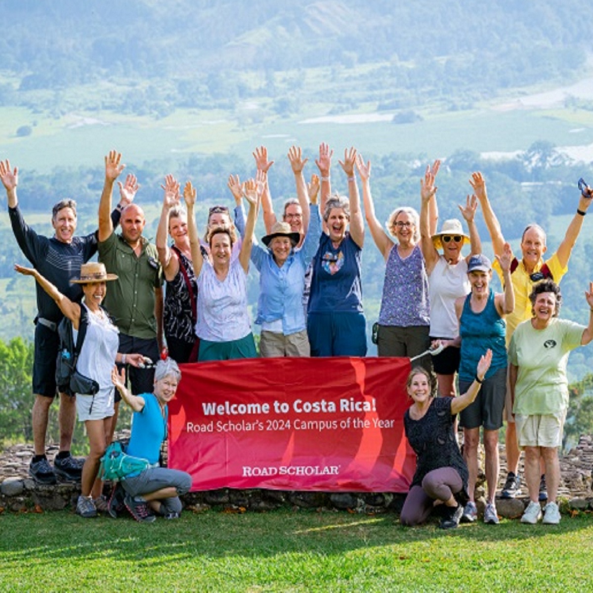 Road Scholars raise their hands in celebration of Costa Rica, our 2024 Campus of the Year