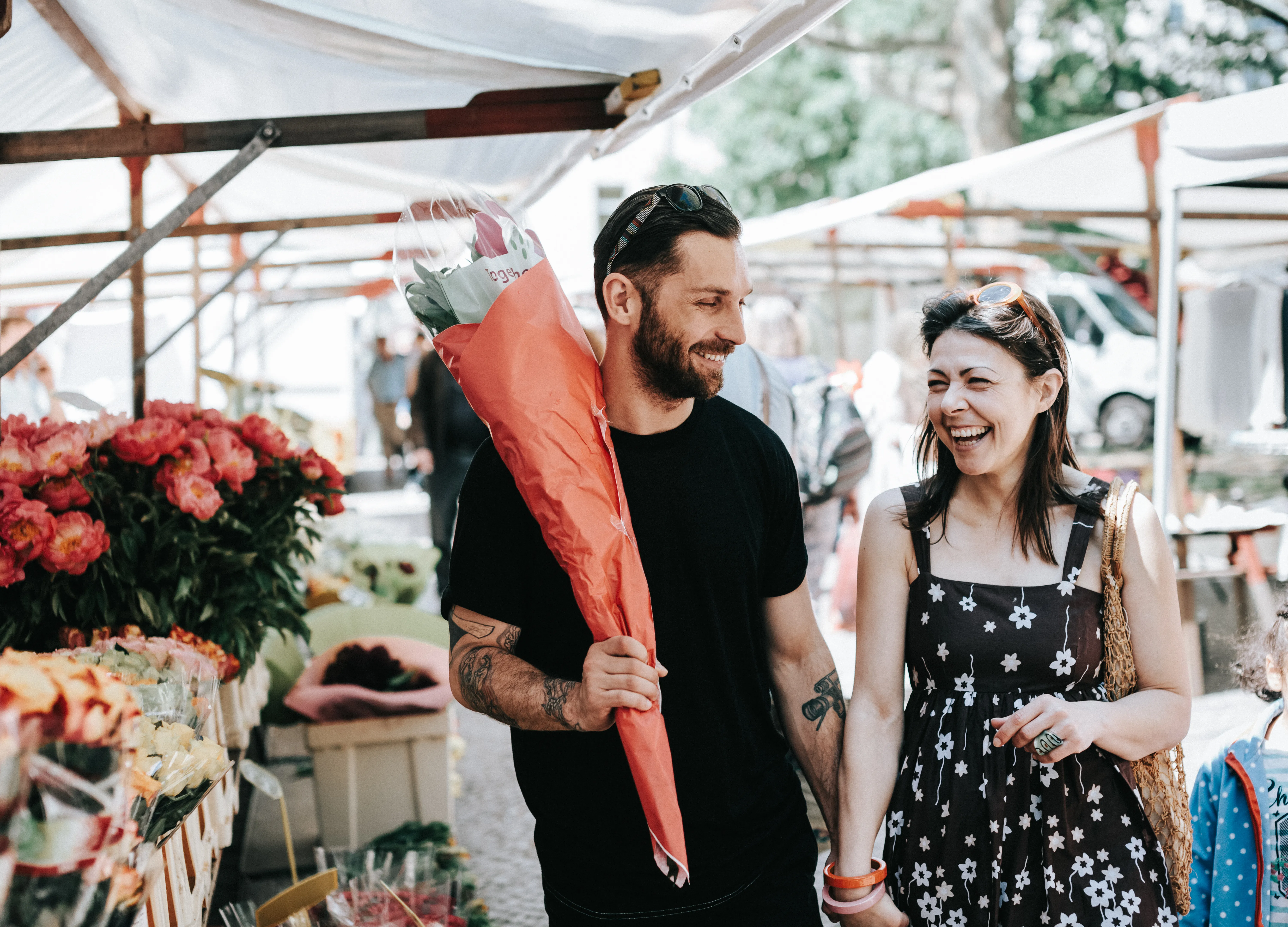 Happy couple walking through Farmer's Market. 