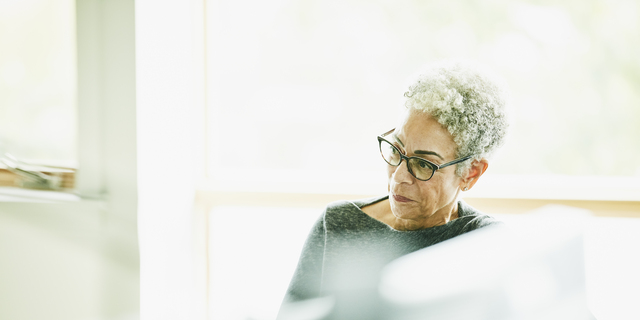 Portrait of senior businesswoman at workstation in design studio