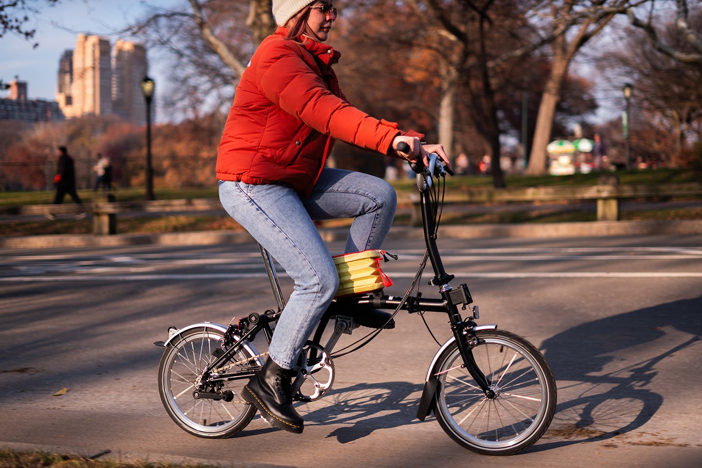 An action shot of a student riding a bicycle [implementing their new designs?]