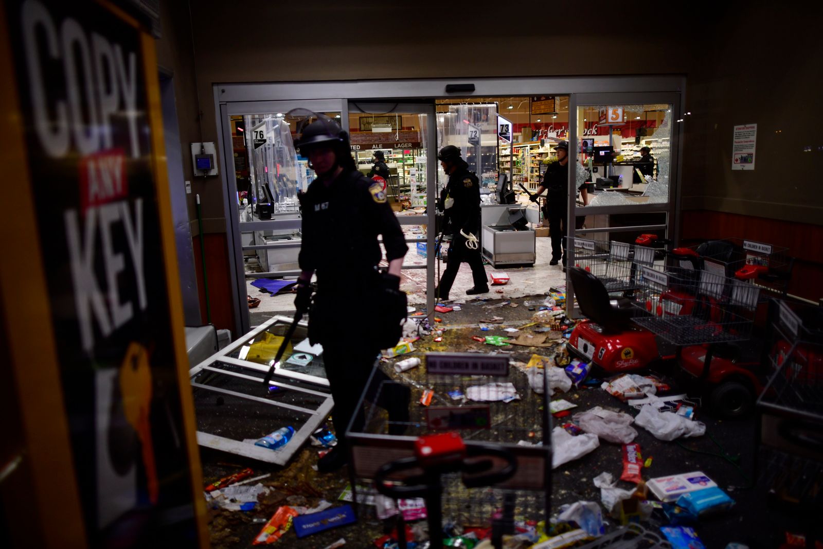 Police in a looted grocery store.