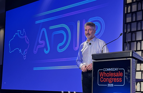 Vocus Chief Technology Officer Nikos Katinakis speaking at Commsday Wholesale Congress 2026 with a slide reading "ADIP" behind him and a map of Australia