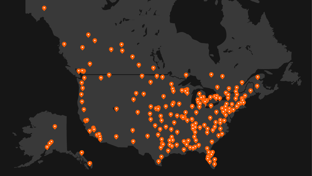 An illustrated map of North America with orange docs across the country to demonstrate the location of DEVELON dealerships.