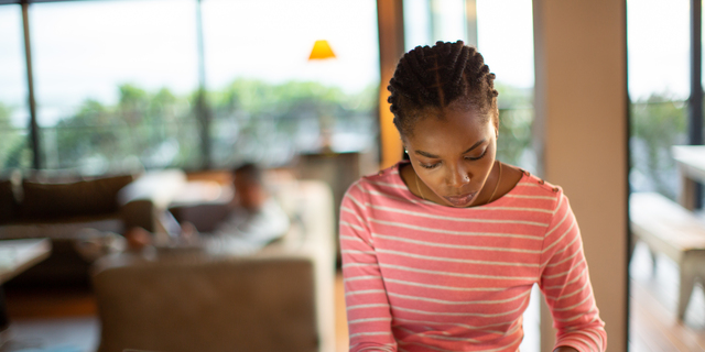 Young woman working on home finances