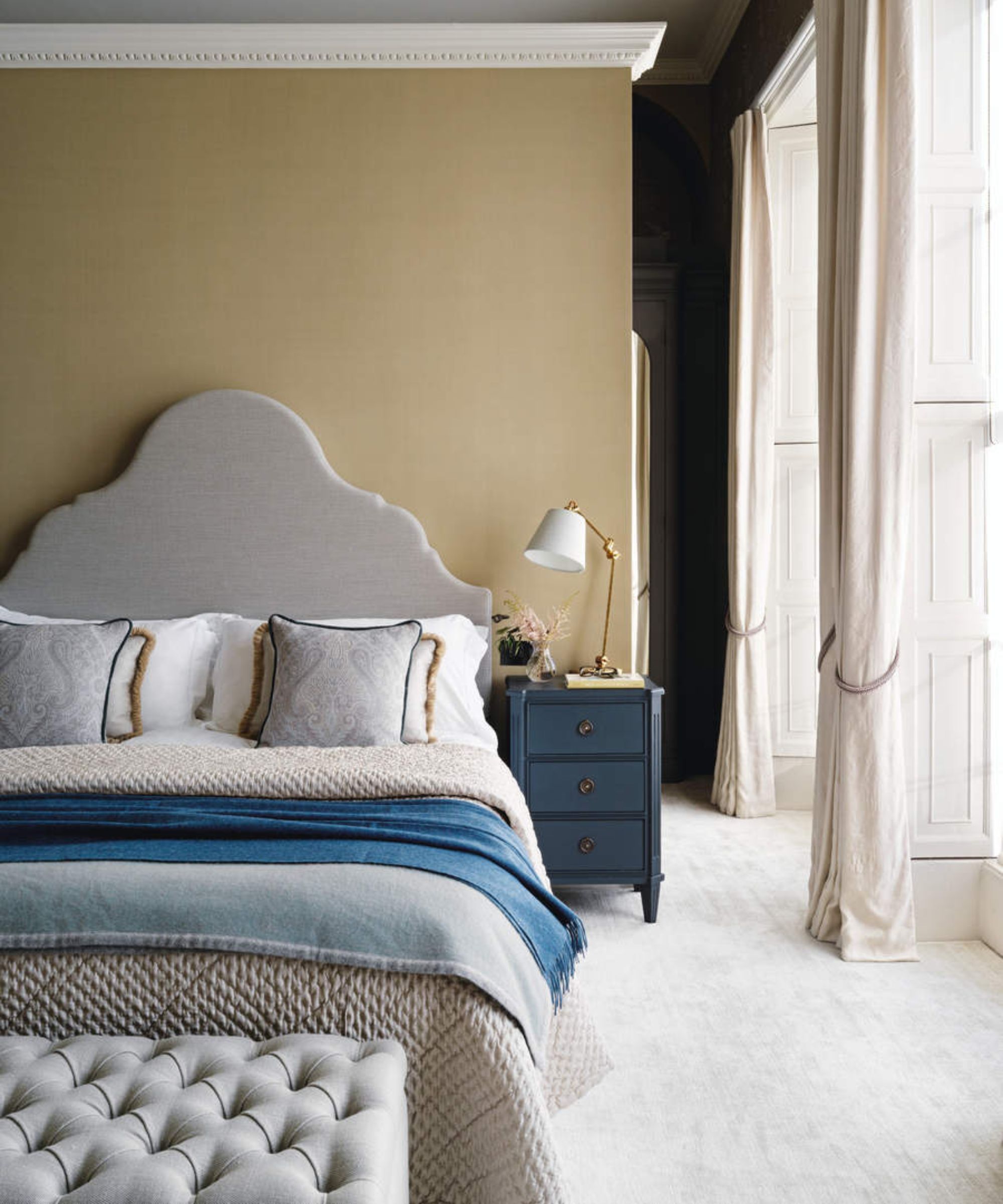 Beige bedroom with gray and blue accessories