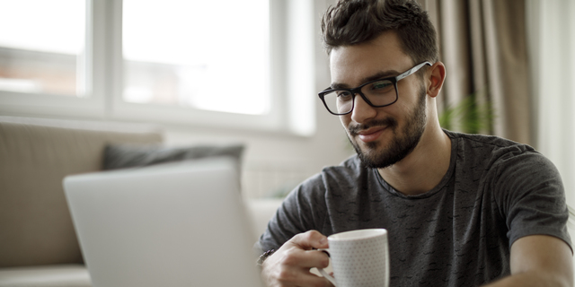 Young man using laptop at home