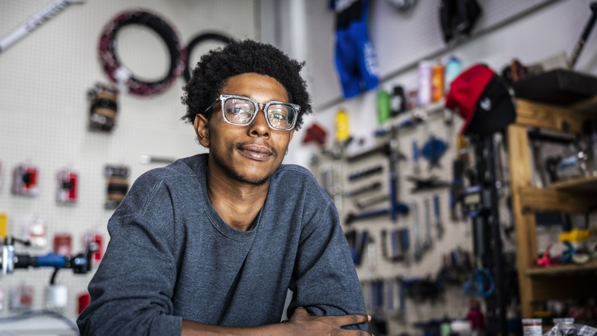 Portrait of bike shop owner leaning on counter