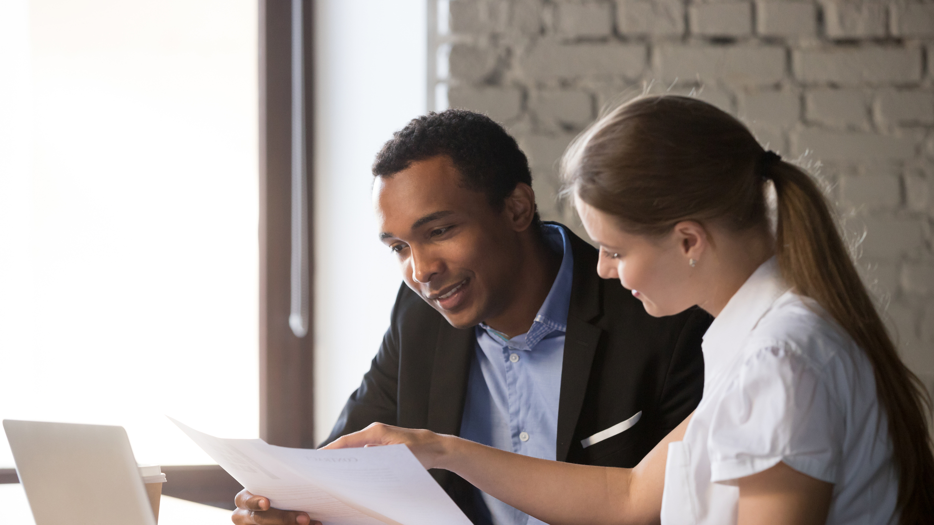 Female financial advisor insurer consulting male african-american client about contract