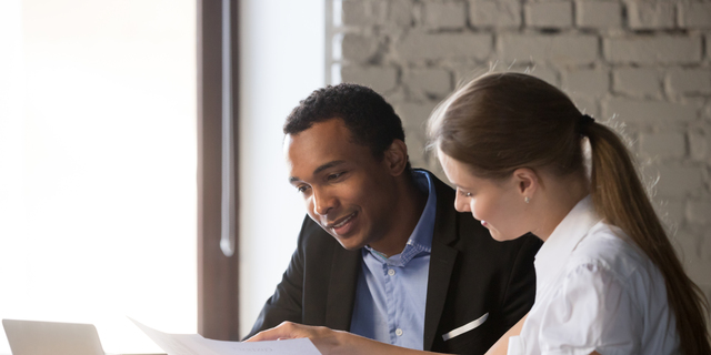 Female financial advisor insurer consulting male african-american client about contract