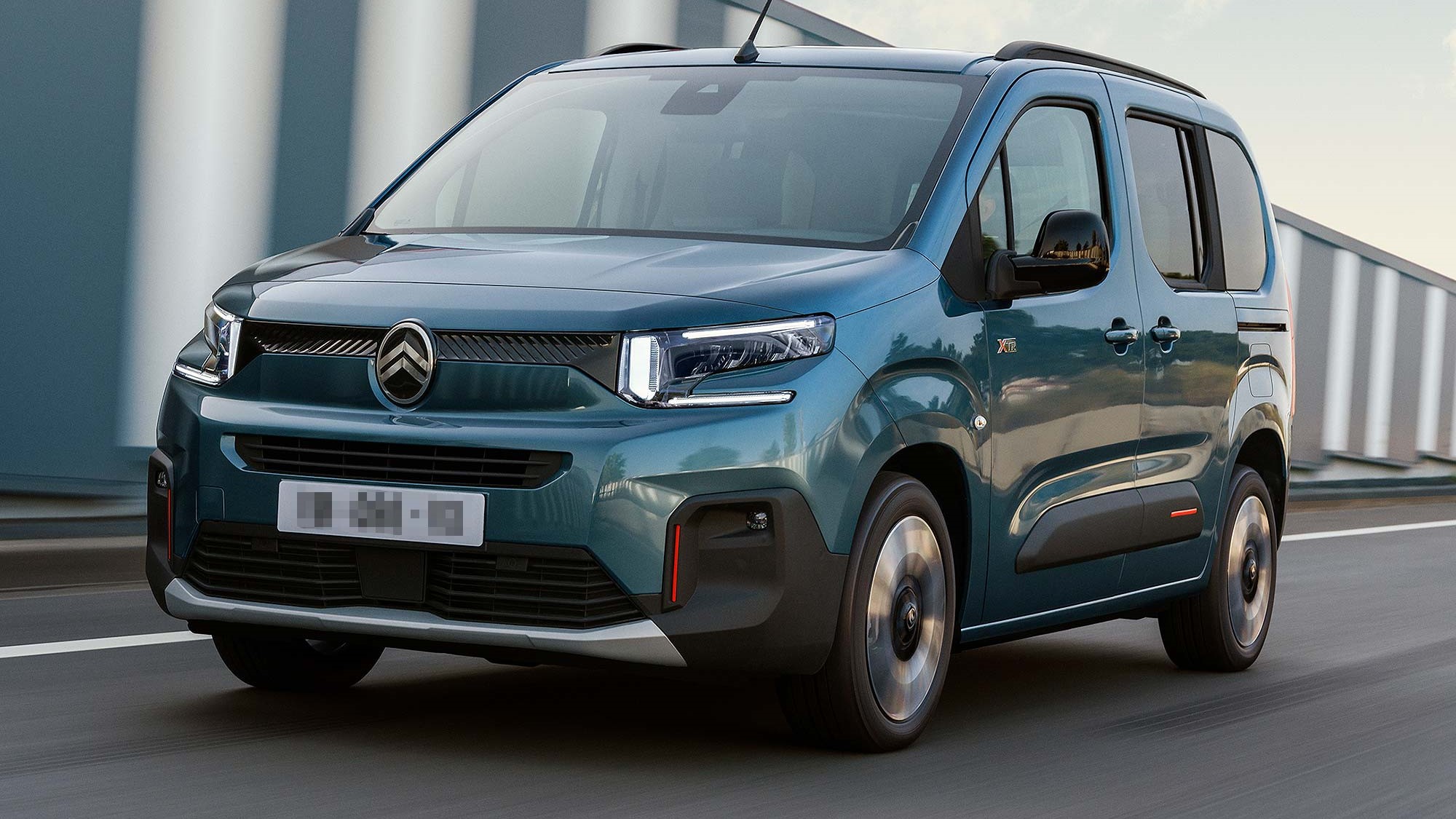 Dark blue Citroen e-Berlingo driving on the road