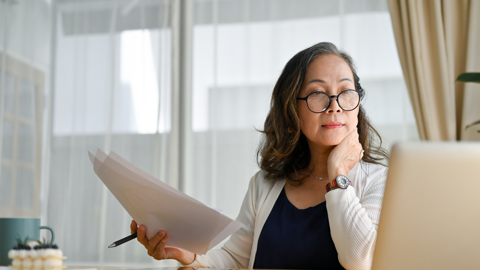 Concentrated asian middle aged female businesswoman using portable computer