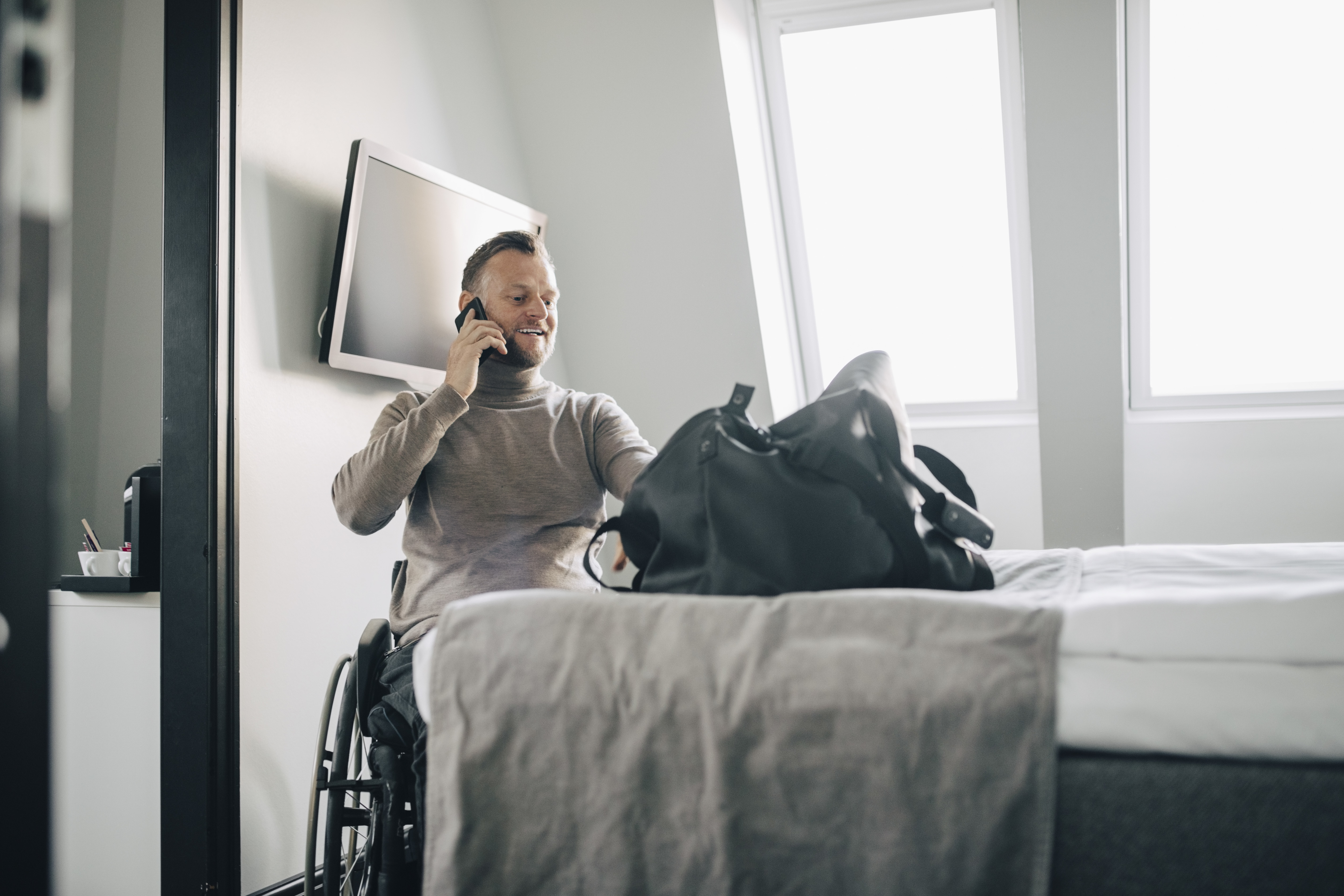 disabled man in an accessible hotel for his summer holiday in the UK